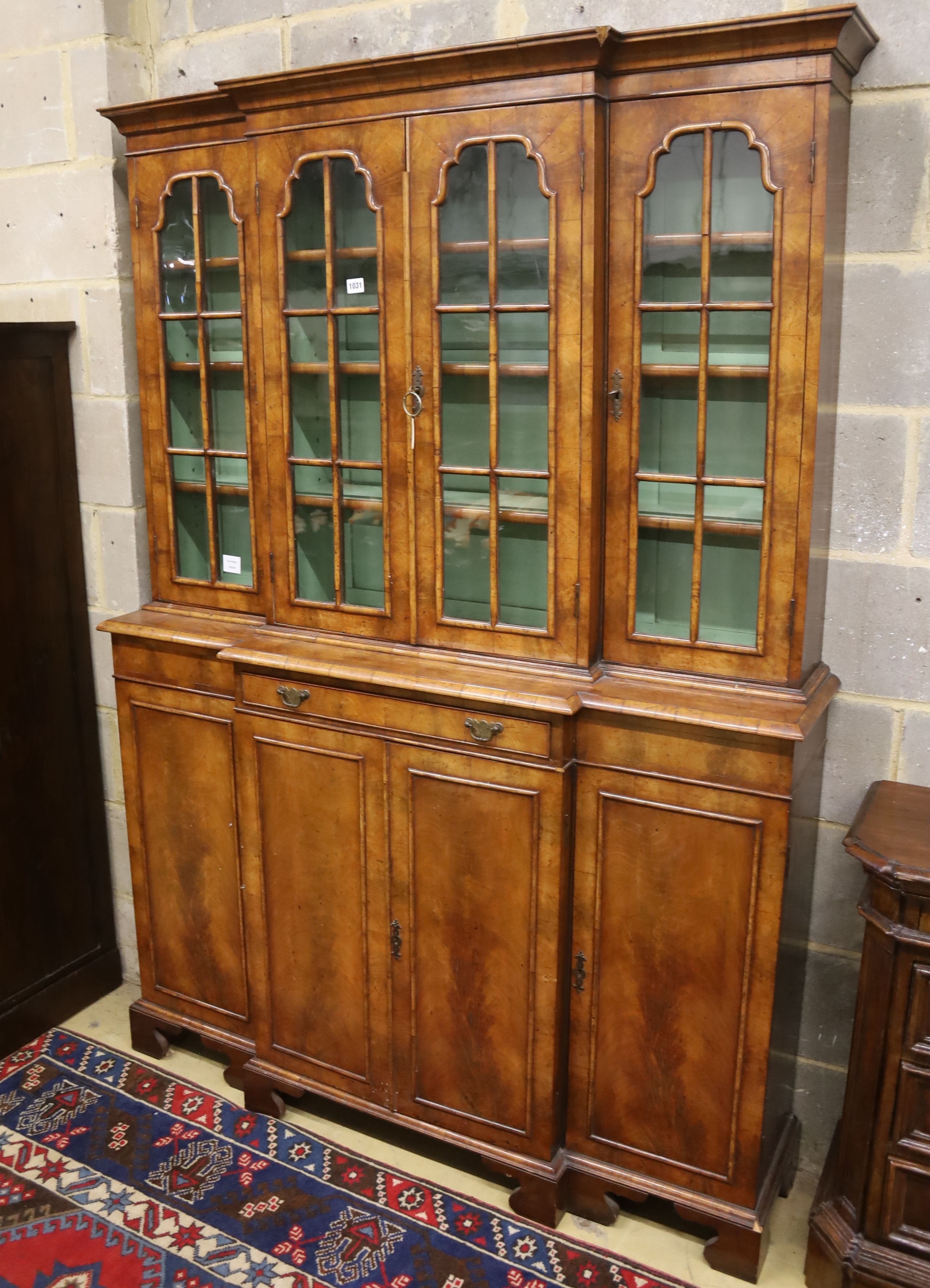 A small Queen Anne revival walnut breakfront library bookcase, length 132cm, depth 34cm, height 190cm